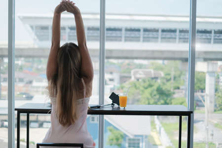 caucasian female playing tablet in morningの写真素材