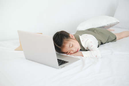 Asian little cut girl learning online at homeの写真素材