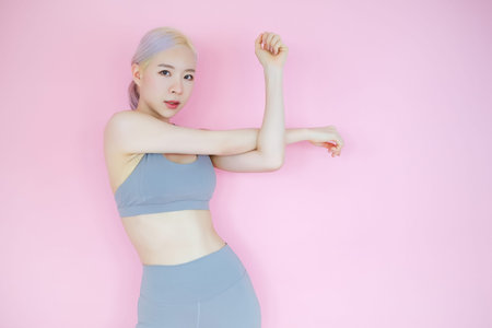 beautiful asian woman on pink background, fitness sports and recreation concept