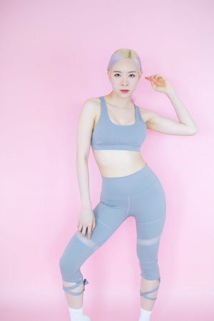 beautiful asian woman on pink background, fitness sports and recreation concept