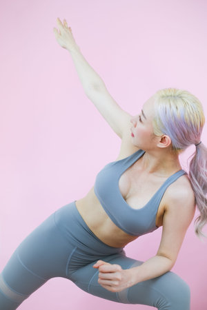 beautiful asian woman on pink background, fitness sports and recreation concept