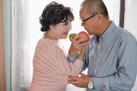 Portrait of happy couple senior asian woman and retirement man having breakfast together