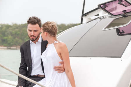 Portrait caucasian couple in love romance on luxury white yacht in oceanの写真素材