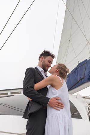 Portrait caucasian couple in love romance on luxury white yacht in oceanの写真素材