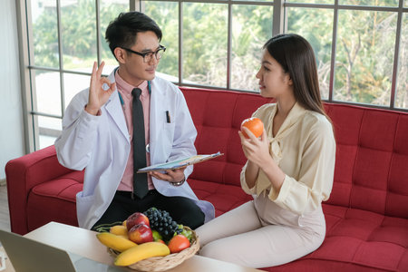 Professional nutritionist asian man consulting asia woman in clinic or hospital or medical clubの写真素材