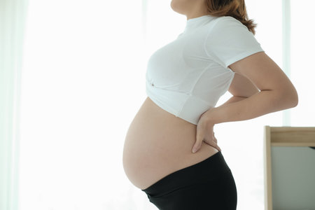 asian pregnant woman have a backache