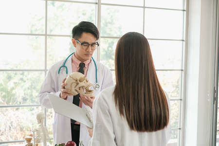 Portrait of male dentist and professional asian woman in clinic or hospital or medical clubの写真素材