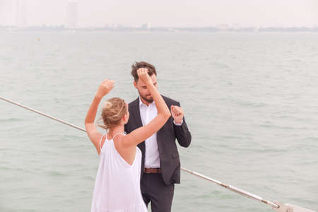 Portrait caucasian couple in love romance on luxury white yacht in oceanの写真素材