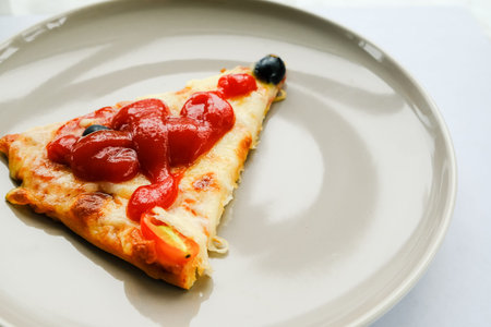 slice Pizza pepperoni on plate with catchup topping on dish