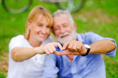 Portrait caucasian senior woman and old man, couple elder in love happy in the parkの写真素材