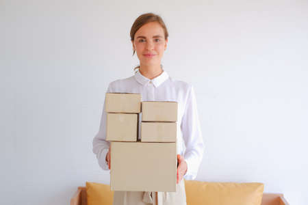 working woman sit on sofa shopping online with smart phone or mobile phoneの写真素材