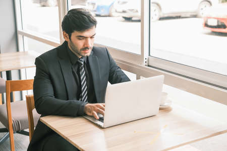 business caucasian man sitting in working in co working space near windowの写真素材