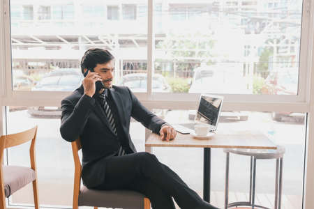 business caucasian man sitting in working in co working space near windowの写真素材