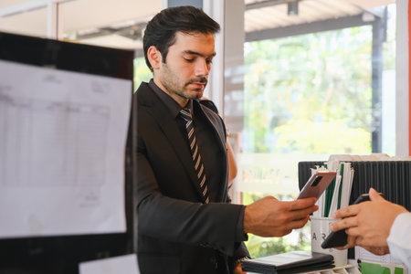 asian waiter serving caucasian businessman in cafe or restaurantの写真素材