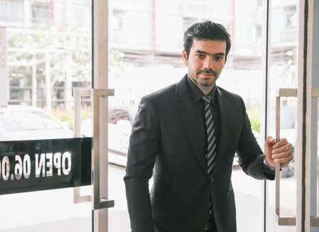 Caucasian businessman is push the doorの写真素材