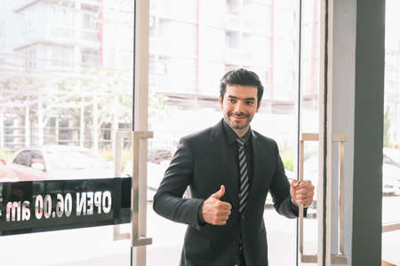 Caucasian businessman is push the doorの写真素材