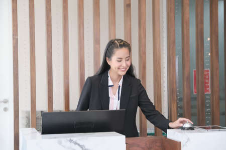 Asian woman receptionist in lobbyの写真素材