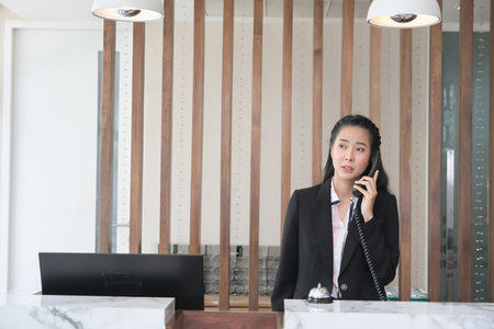 Asian woman receptionist in lobbyの写真素材