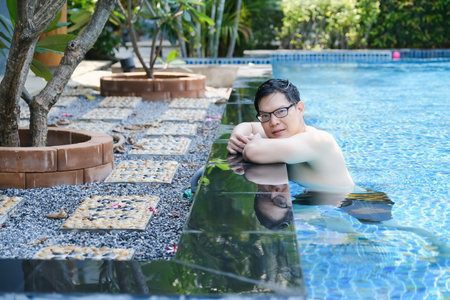 Asian man relaxation on swimming pool