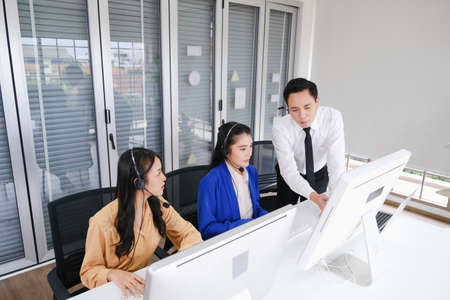 team call center operator with headset in office or workplaceの写真素材