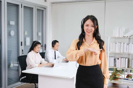 beautiful asian woman working call center operator with headset in office or workplaceの写真素材