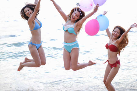 Portrait asian girls wearing swimsuit in seaside happy on the beach, sexy bikini couple ladiesの写真素材