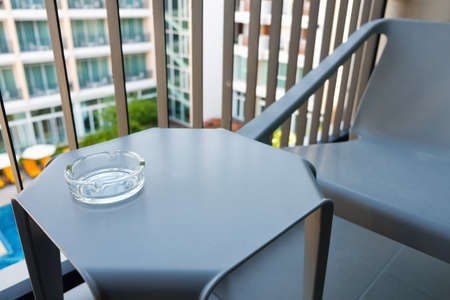 Ashtray on the table in terrace with outdoor viewの写真素材