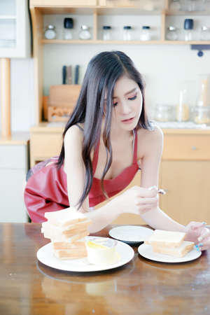 Portrait sexy asian woman wear lingerie or underwear with bread holding in handの写真素材