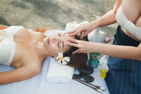 Two asian sexy women doing spa massage together in outdoorの写真素材