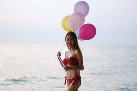 portrait asian woman sexy bikini in seaside happy life on summer seasonの写真素材