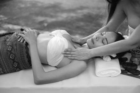 Two asian sexy women doing spa massage together in outdoorの写真素材