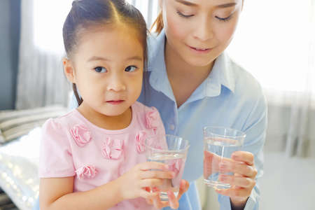 Asian family drinking water with togetherの写真素材