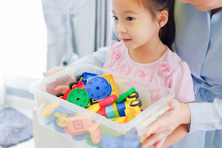 Little cute asian girl playing plastic colorful toysの写真素材