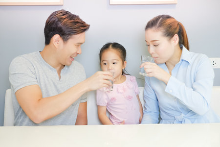 Asian family drinking water with togetherの写真素材