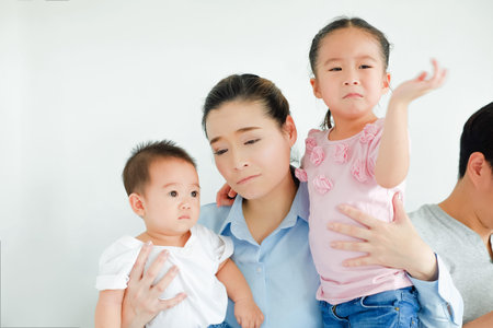tired asian mother's with children
