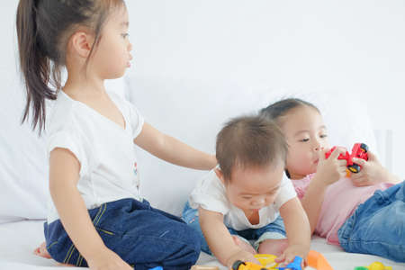 Little cute asian girl playing plastic colorful toysの写真素材