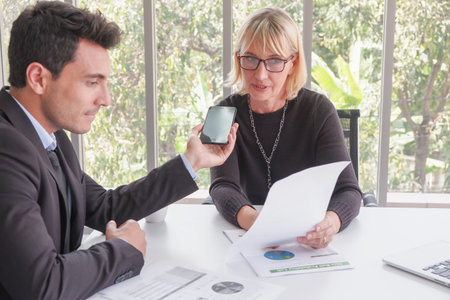 businessman and businesswoman meeting in office room