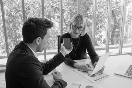 businessman and businesswoman meeting in office roomの写真素材
