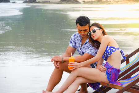 Portrait asian couple in love, sexy bikini on the beach, happy life on summer seasonの写真素材