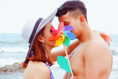 Portrait asian couple in love, sexy bikini on the beach, happy life on summer seasonの写真素材