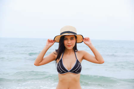 sexy asian woman wearing bikini on the beachの写真素材