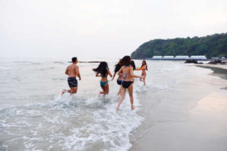 Abstract Blurred sexy bikini asian women wearing swimwear playing with friends in seaside on the beachの写真素材