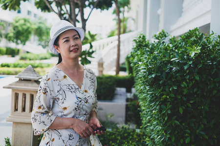 portrait senior asian woman wear a hat in gardenの写真素材