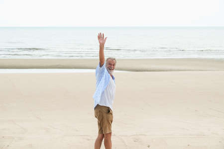 portrait caucasian old man relaxing on the beachの写真素材
