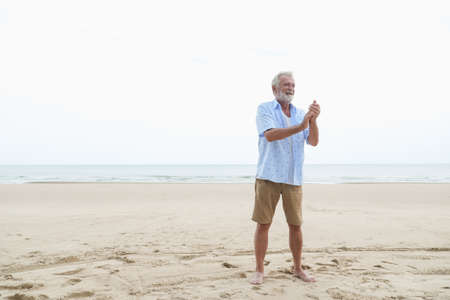 portrait caucasian old man relaxing on the beachの写真素材