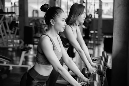asian group friends working out or exercise and wearing sportswear in fitness or gym center, strength sporty and weight loss conceptの写真素材