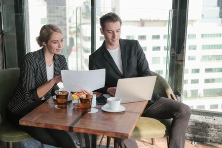 Two businessman and businesswoman couple meeting in co working space at sky lounge or officeの写真素材