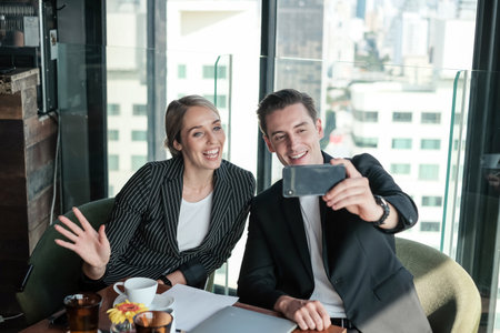 Two business man and woman couple meeting in co working space at sky loungeの写真素材