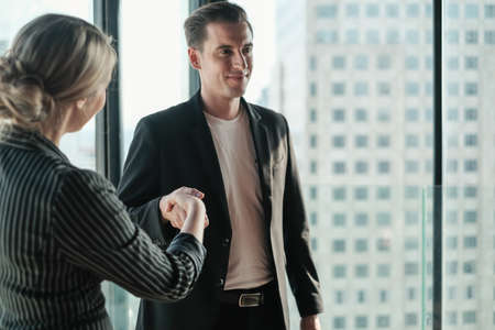 Two businessman and businesswoman couple meeting in co working space at sky lounge or officeの写真素材