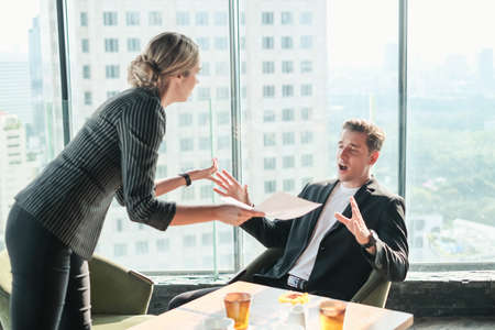 Two businessman and businesswoman couple meeting in co working space at sky lounge or officeの写真素材
